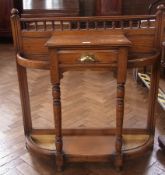 Late Victorian walnut hallstand, bowfronted with raised spindle lowback, single frieze drawer,