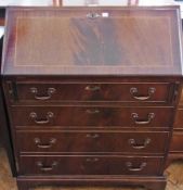 A Georgian style mahogany bureau, with fitted interior, four long graduated drawers on bracket feet,
