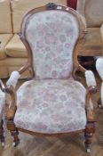 Victorian lady's and gentleman's walnut armchair and sewing chair, with pink upholstery on turned