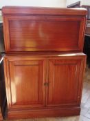 Twentieth century mahogany cocktail cabinet, with panel cupboard below raised on a plinth base,