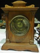 A late nineteenth century oak cased mantel clock, with brass dial and alarm by Fattorini & Sons