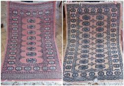 Two pink ground Persian style rugs, decorated with elephants foot guls