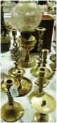 An old brass oil lamp, with engraved glass globe, a pair of open spiral candlesticks, a chamber