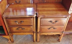 A pair of reproduction bedside chests with two drawers, on shaped legs, width 49cm