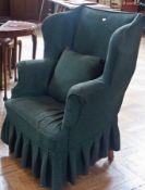 Wing armchair with green cover  and cushion, on straight supports