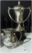 Silverplate hot water jug, with cane handle, and presentation trophy cup from James  Peiris & Co. (