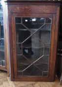 Antique oak corner cabinet with four shelves enclosed by astragal glazed door, 70cm wide