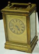 A nineteenth century carriage clock with gilt brass case and glazed panels, the dial with Roman