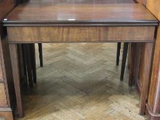 George III mahogany fold over swivel top tea table with moulded edge, plain frieze on square