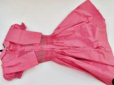 A child's pink cotton smocked dress, age about 9, and a little petticoat