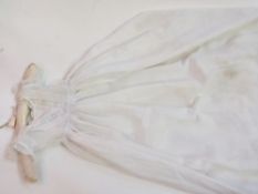 A child's christening gown with lace bodice, pin-tucked hem with three undergarments also with pin-