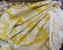 A long yellow blind printed with cream flowers, yellow petal fringe and a  pelmet