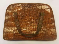 A vintage crocodile skin handbag, the loop handles rather worn