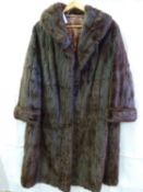 A vintage 1950's fur coat, embroidered silk lining with initials