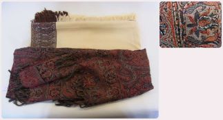 A large cream shawl with brown Paisley border on one side and camels on the other, fringed, with