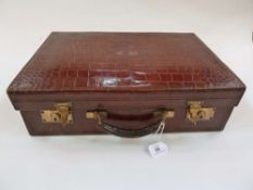 Crocodile travelling case, gilt initials on cover, silk lining, (with key) 47 x 43 cm