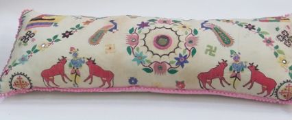 A long rectangular bolster type cushion, embroidered with oriental figures, animals and mirror