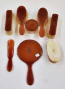 A bakelite backed dressing table set, initialled "ADE" (?), comprising:- powder pot, brushes,