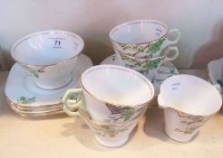 Wellington china part tea service, green flowers on a white ground with gilt rims, four teacups, six