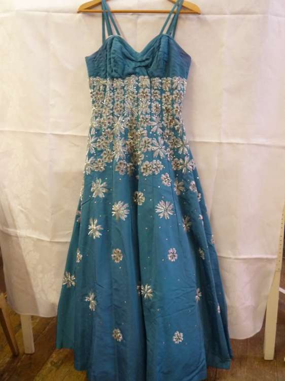 A Samuels, Manchester turquoise satin evening dress heavily embellished with sequins and rhinestones