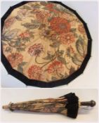 A small parasol, floral design with embroidered edges to flowers, black velvet trim, bone tips to