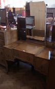 Twentieth century oak mirror-back dressing table, the central frieze drawer flanked by a pair of