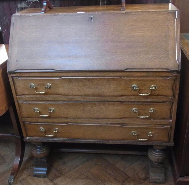 Mid-twentieth century oak bureau, the interior fitted with pigeon holes and drawer, three long