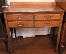 An Edwardian walnut and mahogany banded side table, fitted four drawers on square tapering