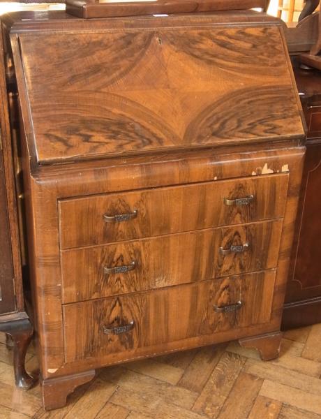 Twentieth century walnut veneer bureau with fitted interior, three long drawers on bracket feet,