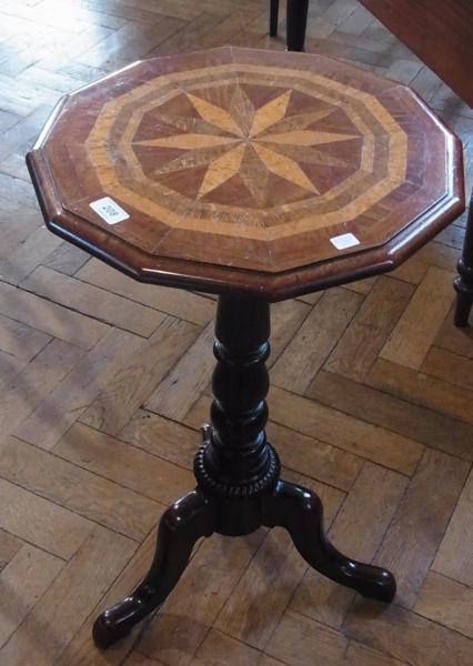 An antique mahogany occasional table with circular top, with canted corners and marquetry inlay,