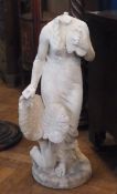 A weathered marble statue of a classical female figure holding a dove (damaged - no head)