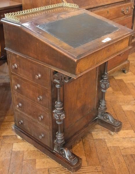 A Victorian walnut Davenport with brass gallery surround, inset leather writing surface, fitted