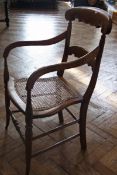 Nineteenth century decorative elbow chair, with canework seat