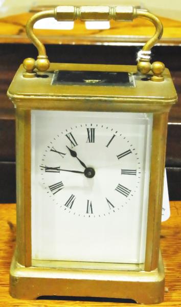 Brass finish carriage timepiece, with white enamel dial and Roman numerals, 5Â½" high over the