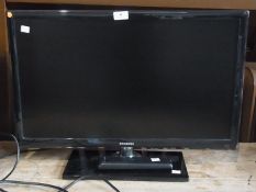 A Samsung flat-screen television together with remote control