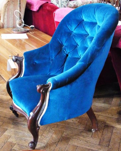 Nineteenth century highback armchair, upholstered in blue buttonback velvet, on shaped serpentine