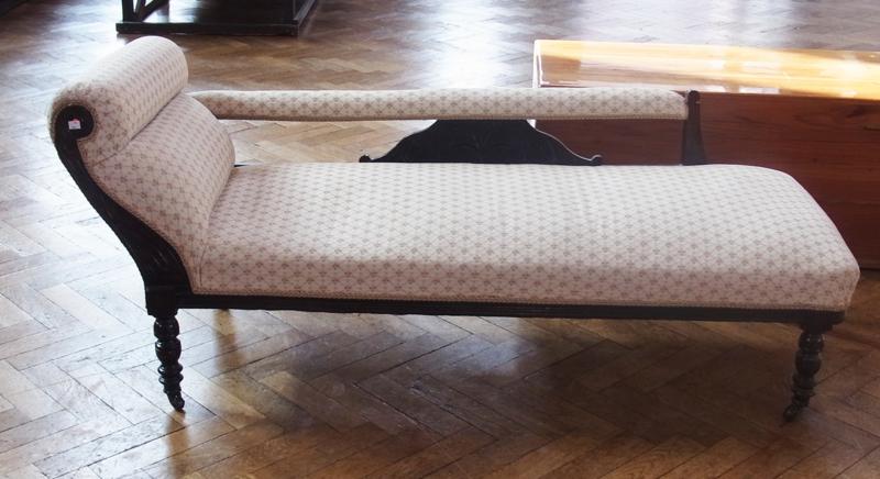 Edwardian framed stained wood chaise longue, on turned supports and brass castors, upholstered