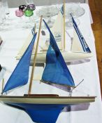 Two various pond yachts in blue and white