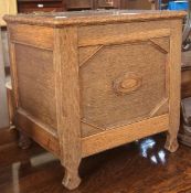 Twentieth century oak sewing box, with brass strap hinges, geometrical moulded front panel on carved