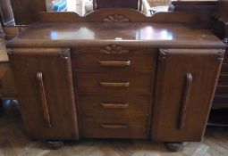 Mid twentieth century oak sideboard, the four central short drawers flanked by cupboards enclosing