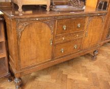 Twentieth century oak sideboard with splashback, reeded frieze with slides, three central frieze