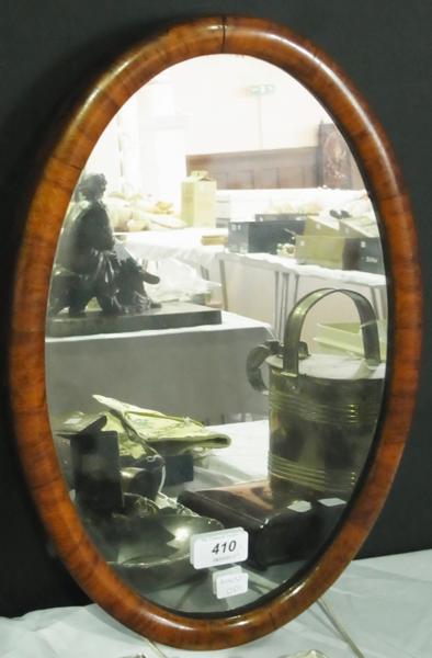 A pewter jug with serpent handle on a raised foot, together with an oval wooden framed wall mirror