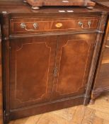 A reproduction mahogany side cupboard with frieze drawer, pair of panelled doors enclosing shelf,