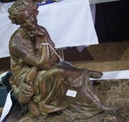 A spelter model of a seated classical maiden, holding a mask, raised on a square marble plinth, 30cm