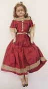 A Victorian wax-headed doll, blue eyes, composition legs and arms, jointed, wearing Victorian