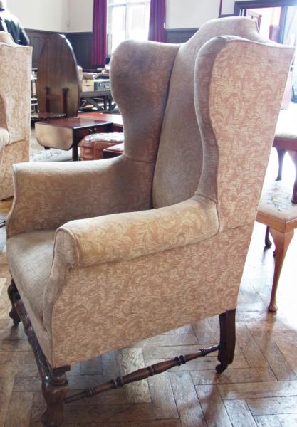 Highback wing armchair, on oak supports and rail
