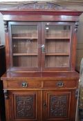 A late Victorian mahogany glazed bookcase, the pair of doors enclosing adjustable shelves, two