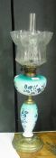A Victorian opaque glass oil lamp, with blue and white floral pattern reservoir and pedestal with
