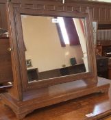 Oak swing framed dressing table mirror, the rectangular plate with square supports, to a platform