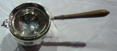 A silver tea strainer with turned wooden handle and bowl, Sheffield 1933 (2)